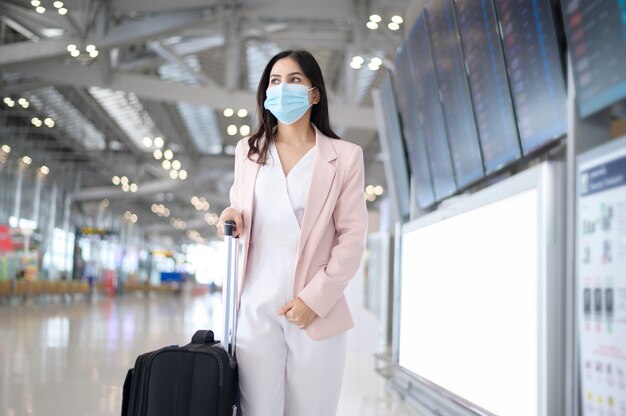 business-woman-is-wearing-protective-mask-international-airport-travel-covid-19-pandemic_33799-8480