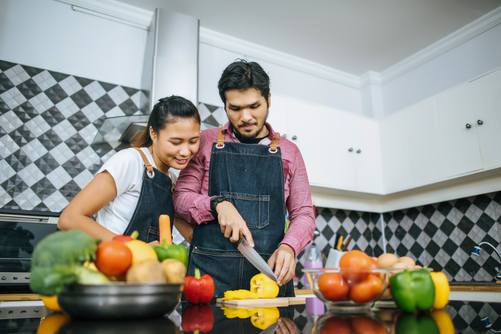 happy-young-couple-help-each-other-chopping-vegetable-preparing-cooking-kitchen (1)