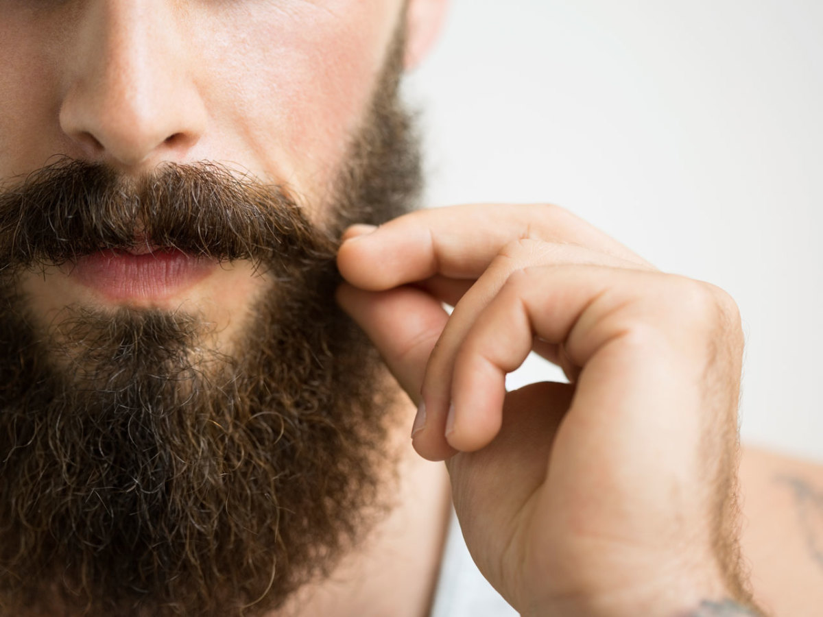 close-up-of-man-touching-mustache