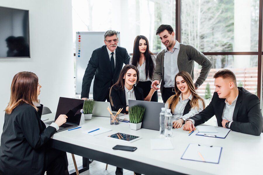 staff-meeting-group-young-modern-people-smart-casual-wear-discussing-something-while-working-creative-office-business-time_496169-1626